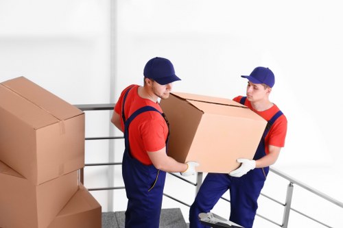 Removal team carefully loading furniture with safety equipment