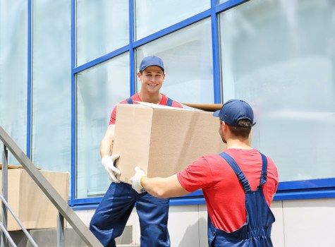 Staff wearing PPE while carrying items during removals