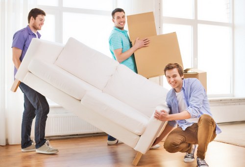 Removal team handling boxes and furniture for a Watford property move