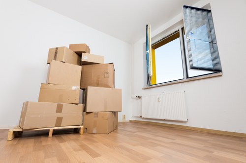 Household furniture and boxes being loaded for transport in Watford