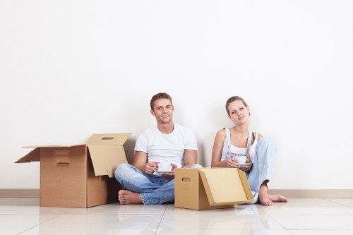 Professional movers handling furniture and boxes during a Watford home move