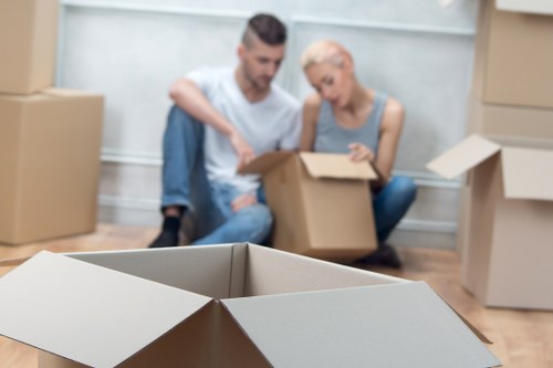 Packed moving boxes and furniture ready for removal services in Watford